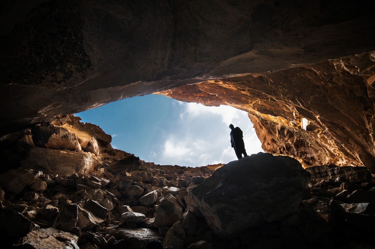 Climb inside Heet Cave to discover a hidden lake in a chamber.