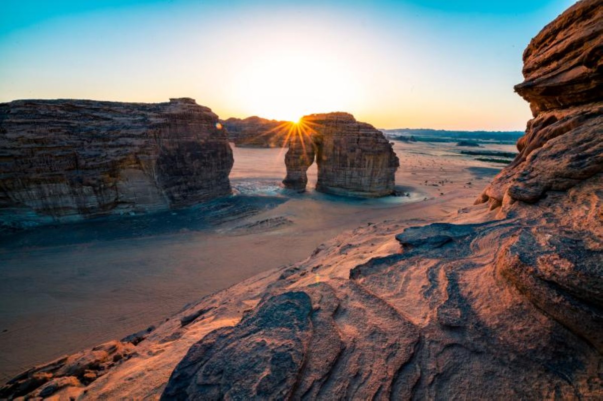 See the sun drop beneath the horizon under the trunk of Elephant Rock