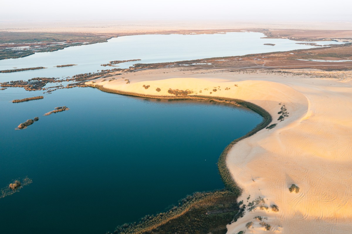 The colours of the sky are reflected in Asfar Lake