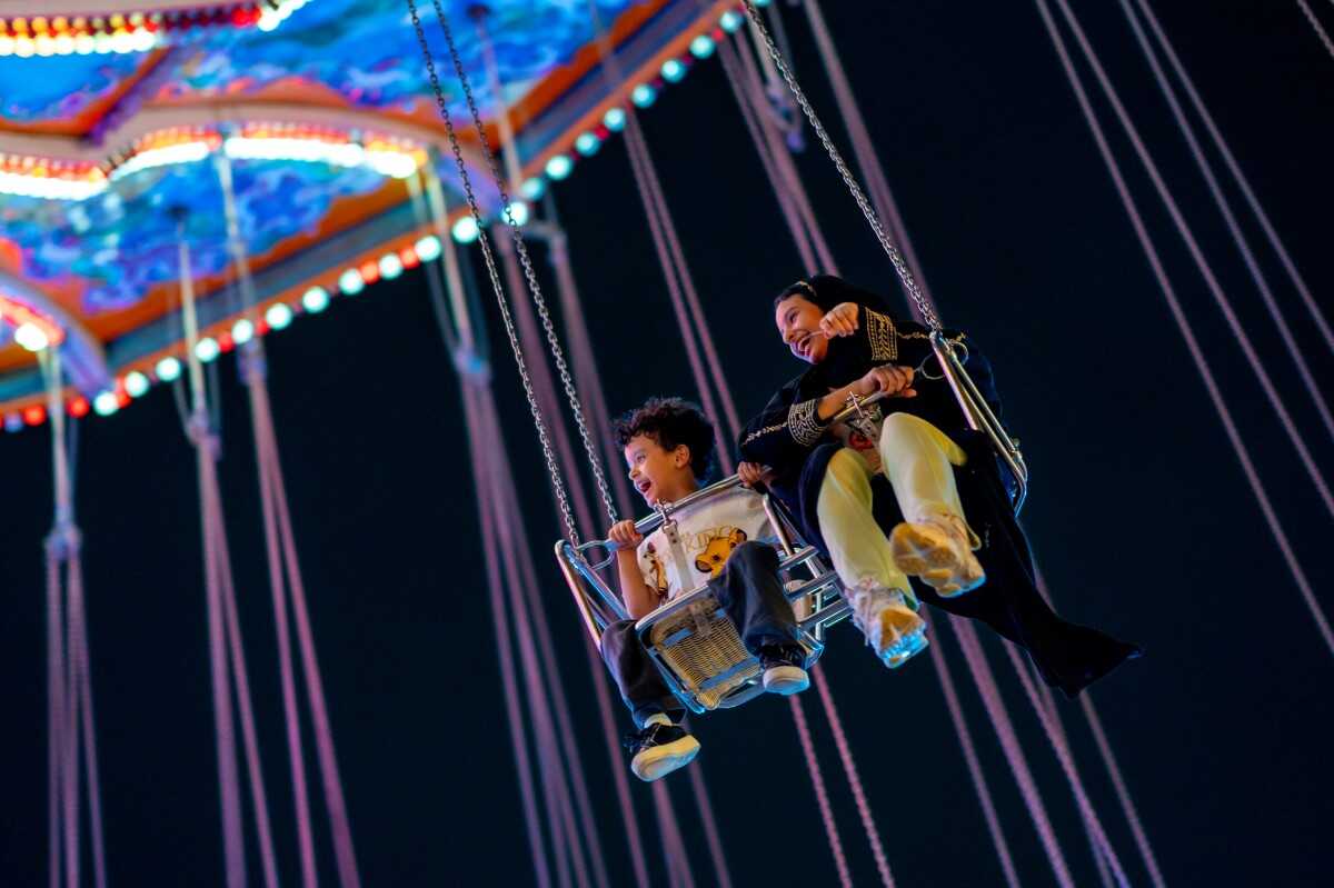 Swing through the night air at Atallah Happy Land