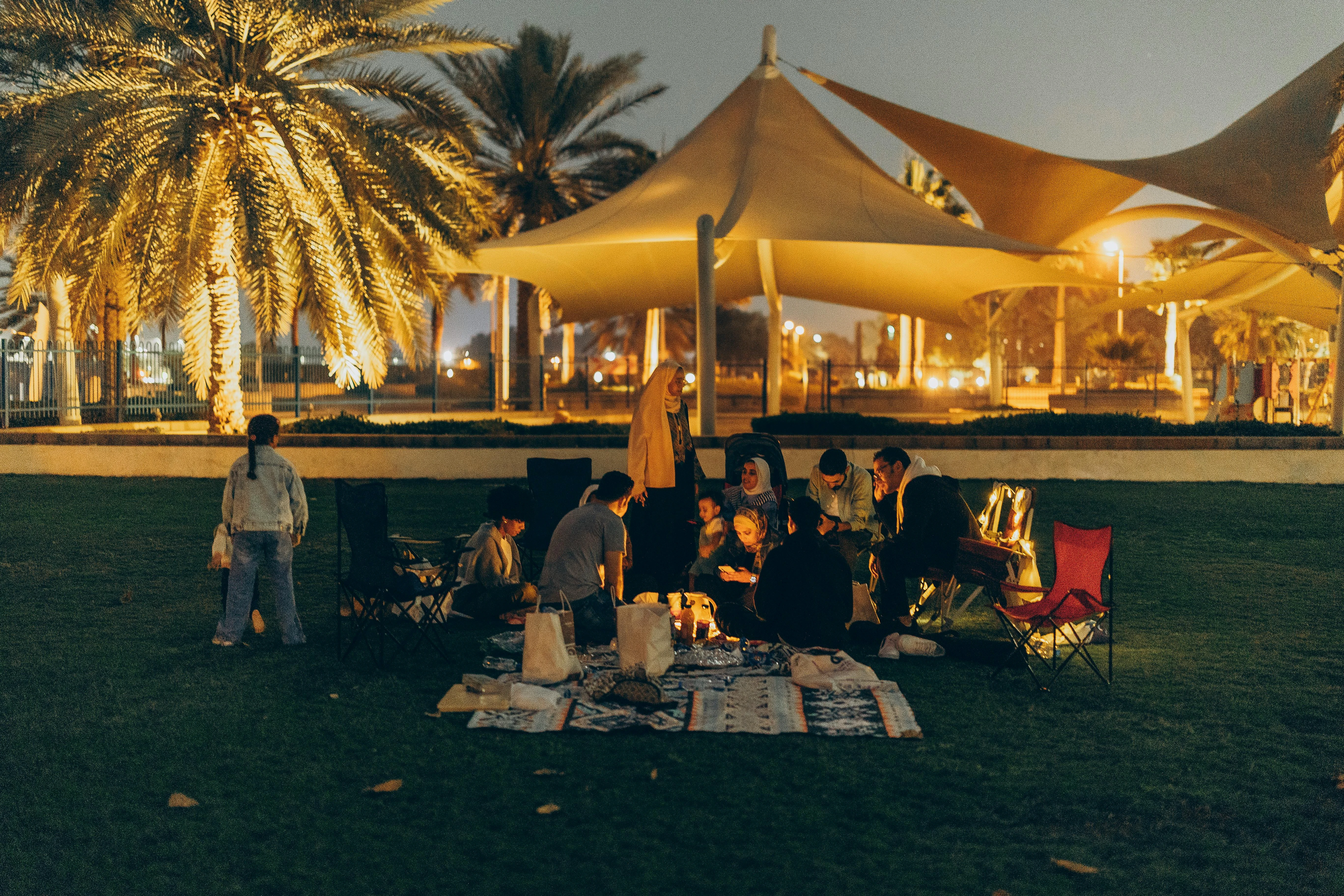 A family enjoying a picnic in the park in Abu Dhabi. Pexels
