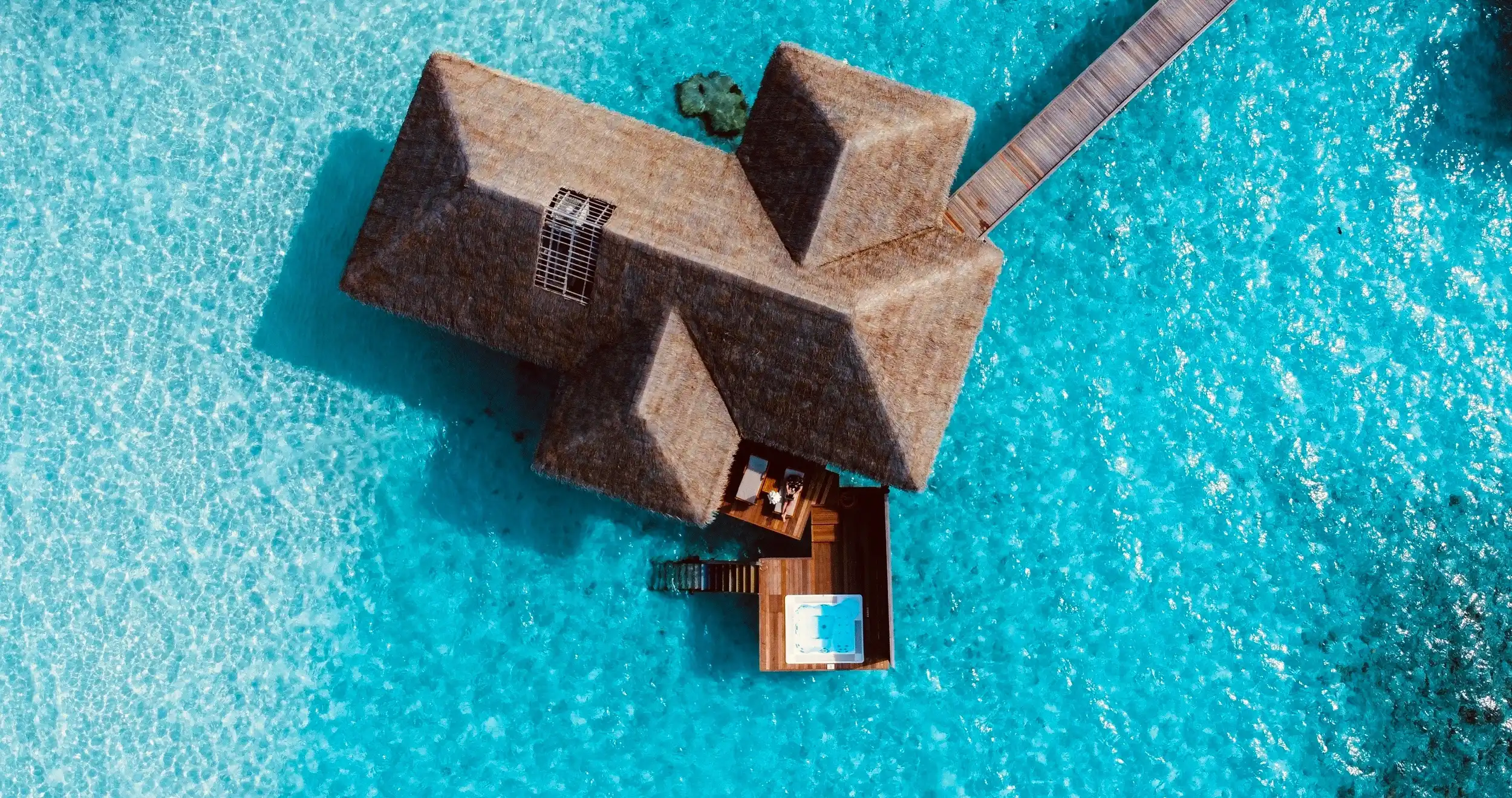 A luxury overwater bungalow in the Maldives. Unsplash