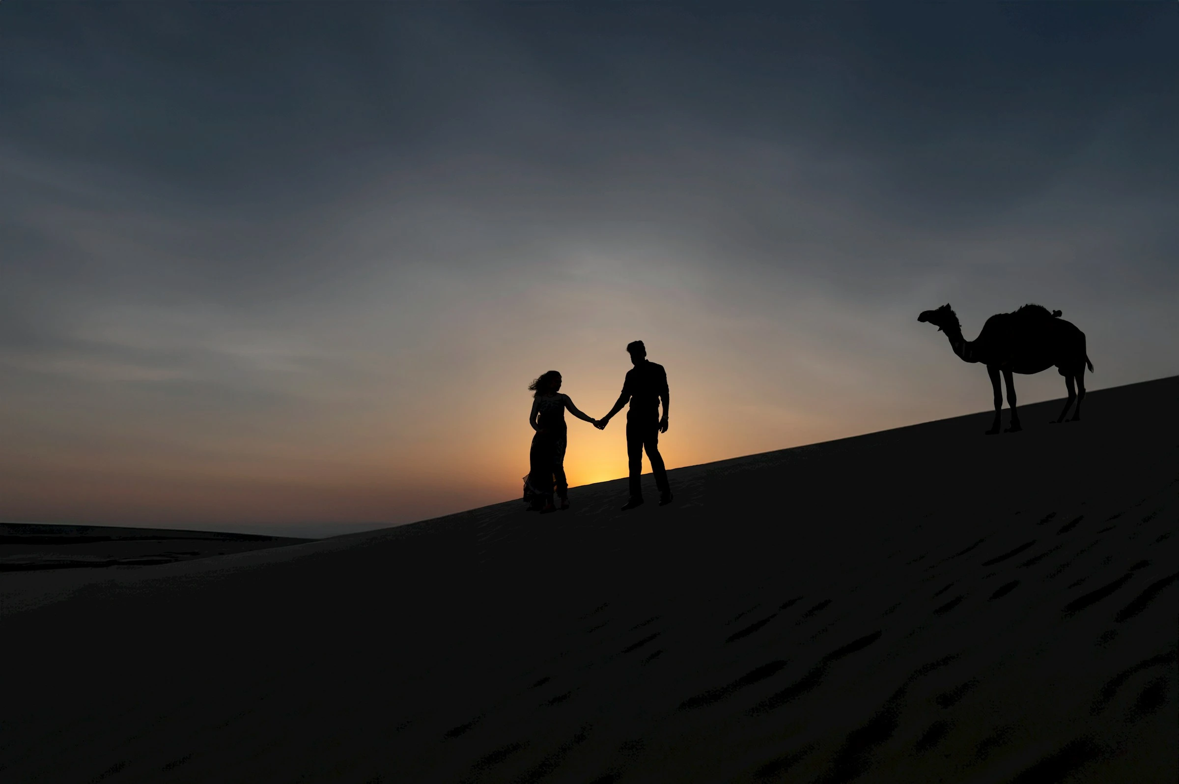 A couple enjoying a desert safari in the UAE. Abdul Raheem Kannath/Unsplash
