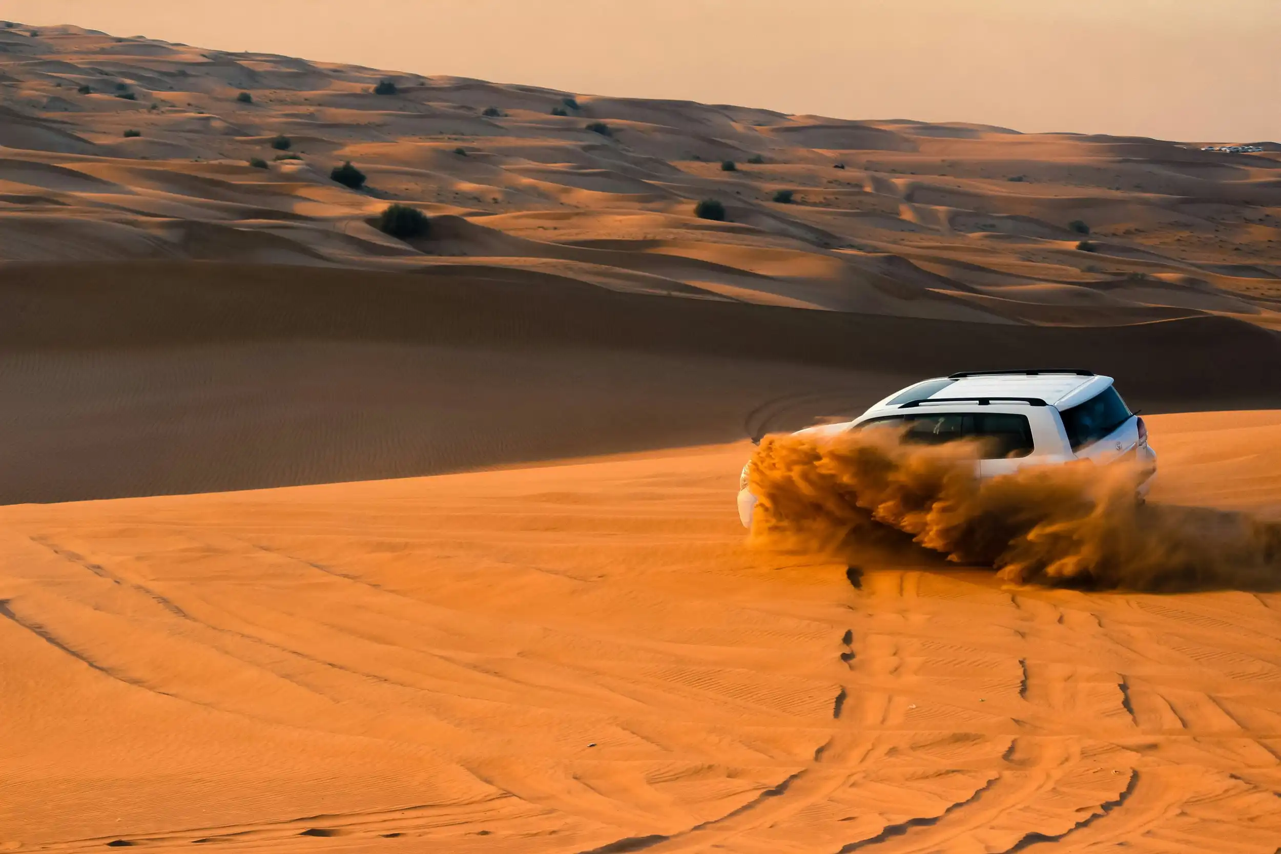 Dune bashing in a 4x4. Unsplash