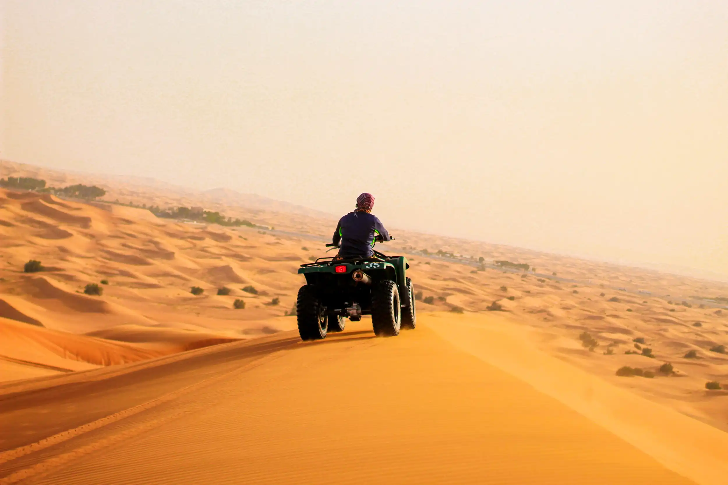 Quad biking in the desert. Unsplash