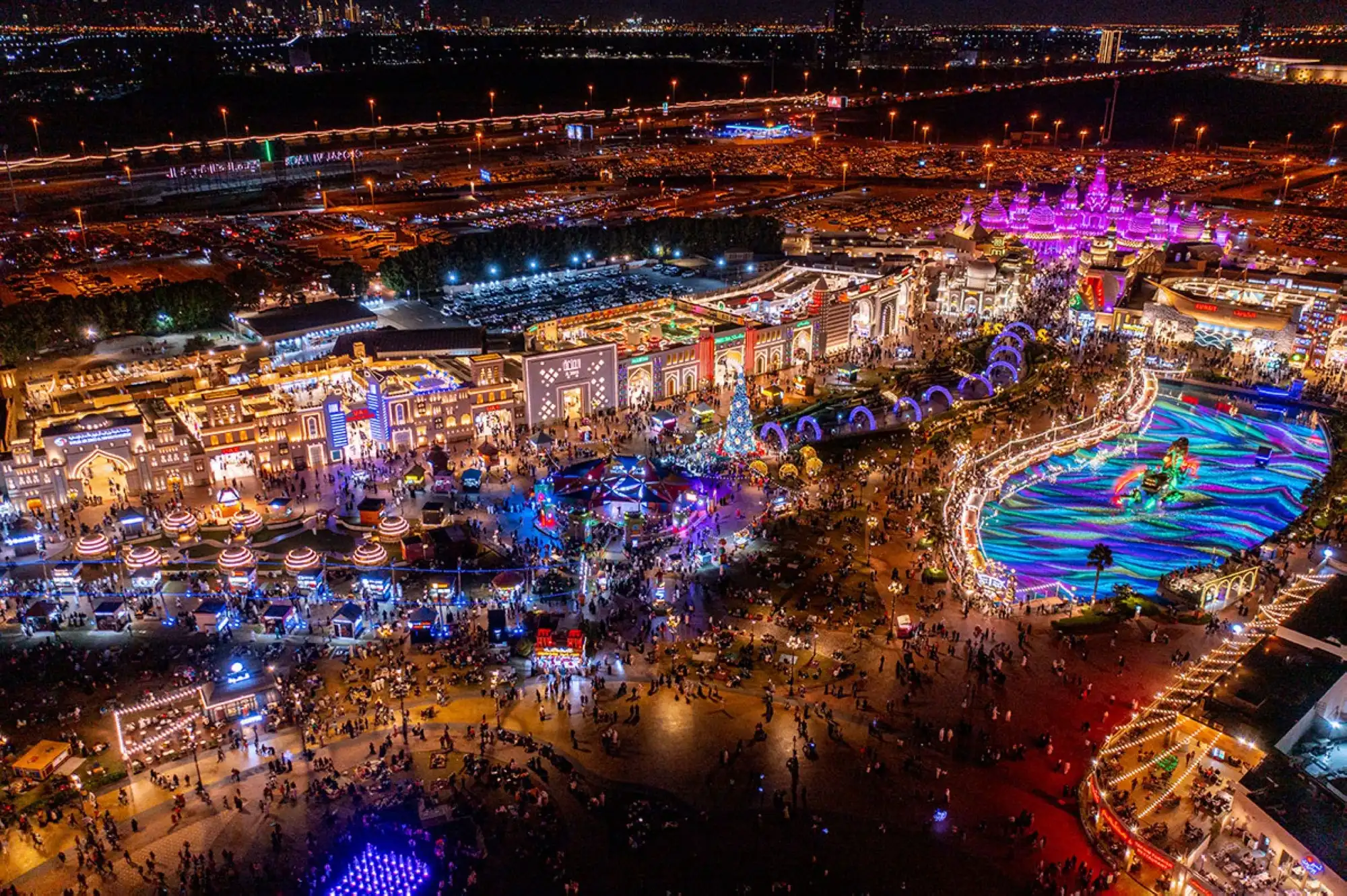 The neon lights of the Global Village at night.
