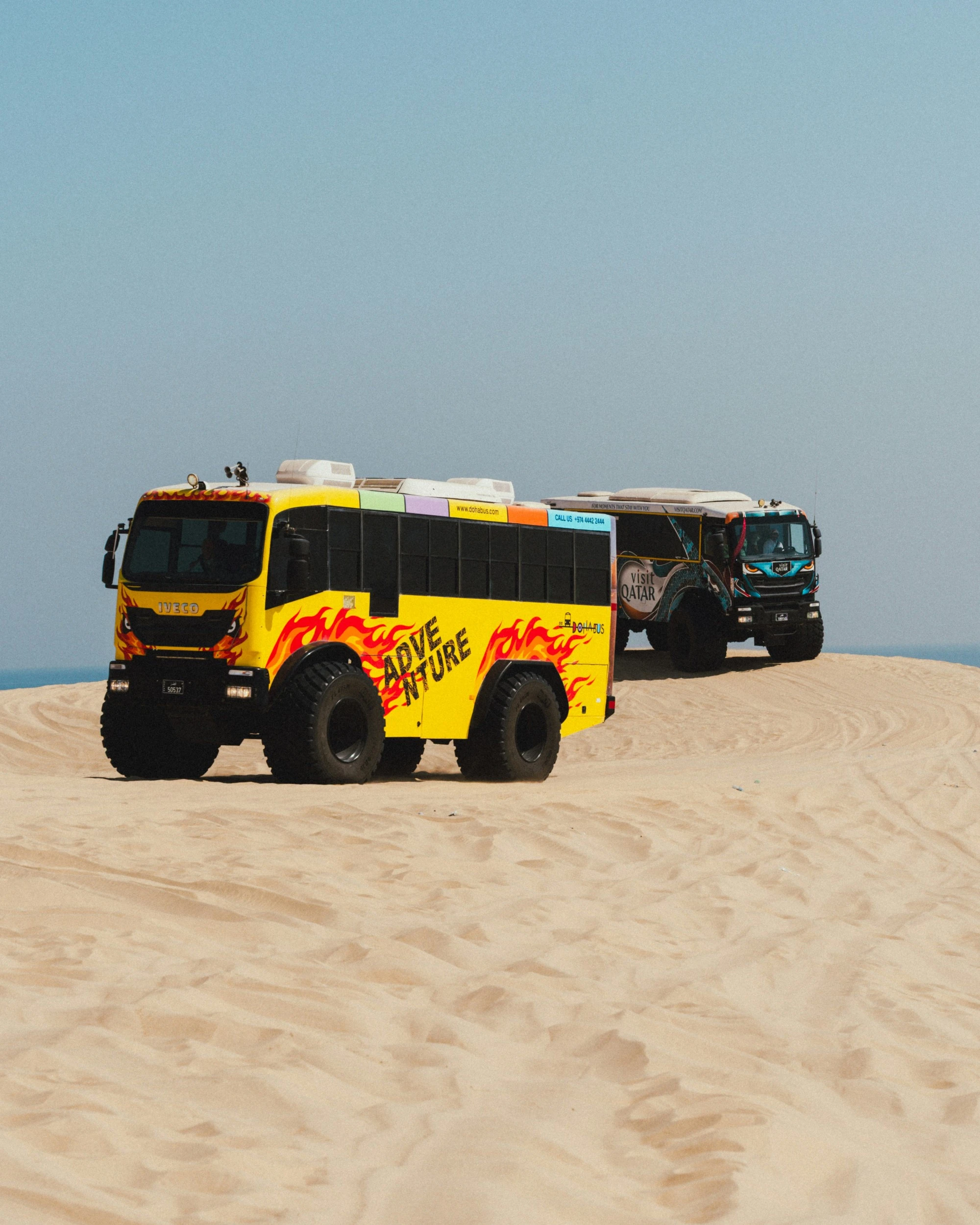 Safari trucks exploring the desert. Unsplash