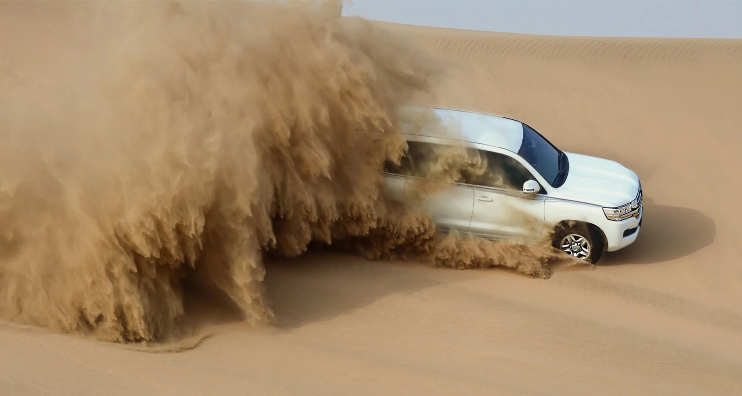 Driving across the dunes near Khor Al Adaid.