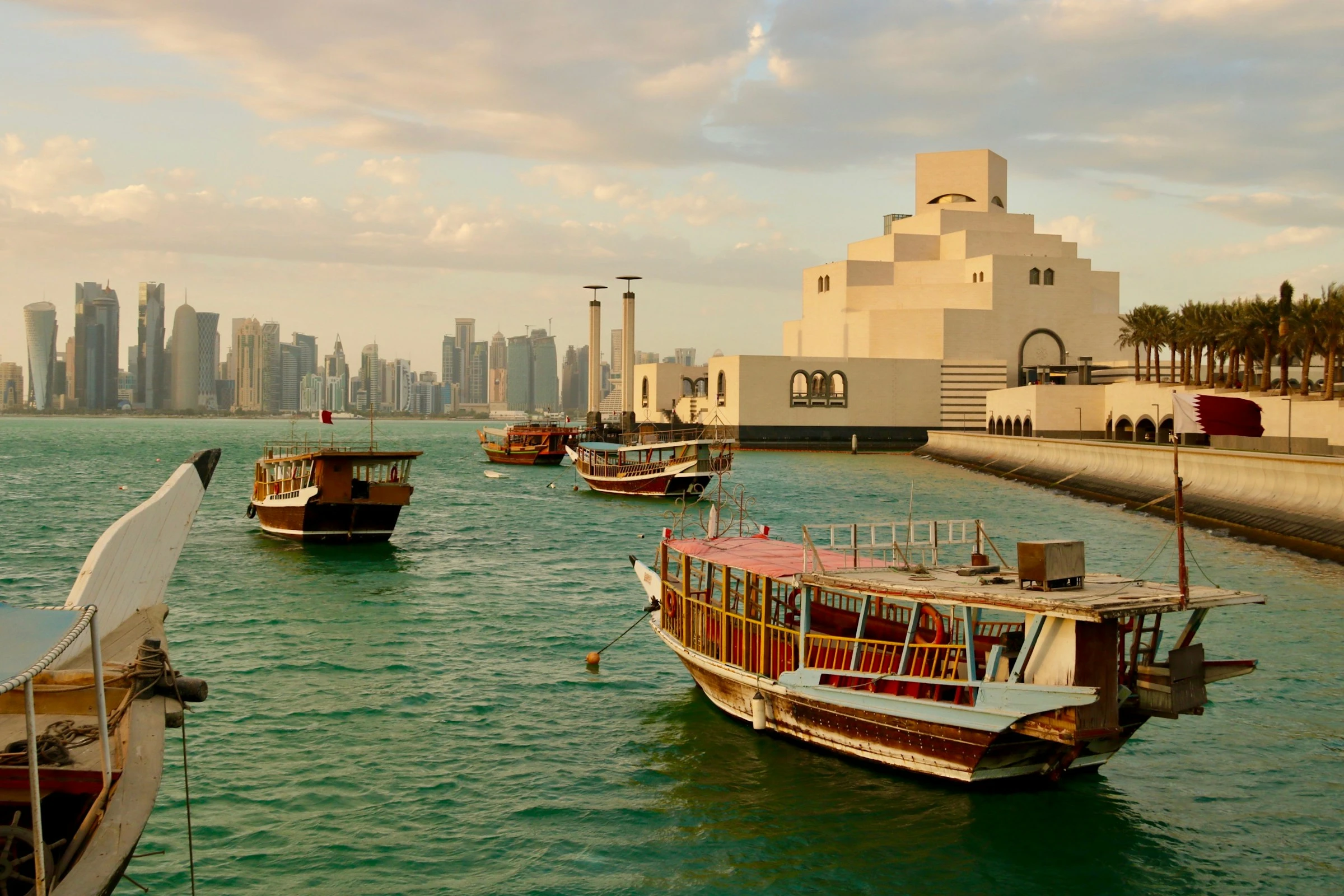 Traditional dhow boats in Doha's harbour. Unsplash
