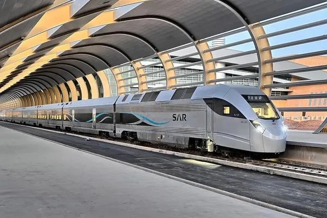 A high-speed train waiting at a platform in Saudi Arabia
