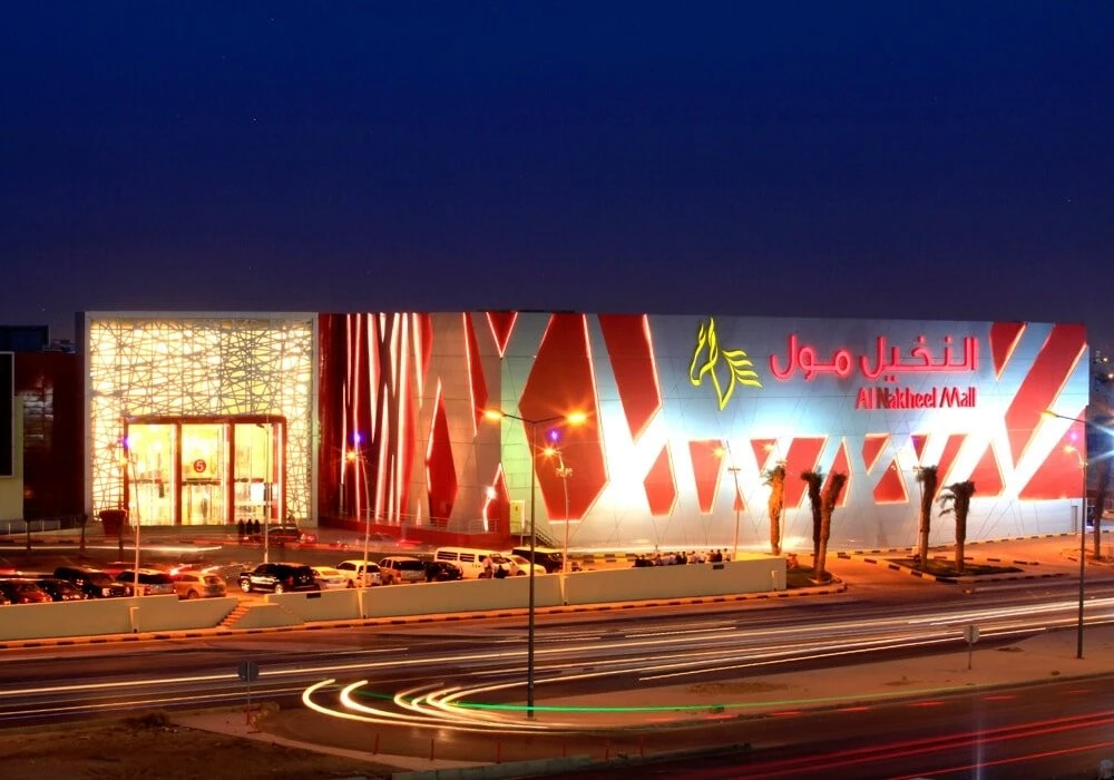 The brightly coloured exterior of Al Nakheel Mall at night