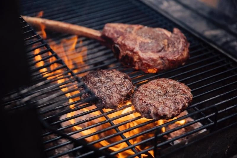 Perfect cut of steak and burgers on an open grill at Marble, Riyadh.