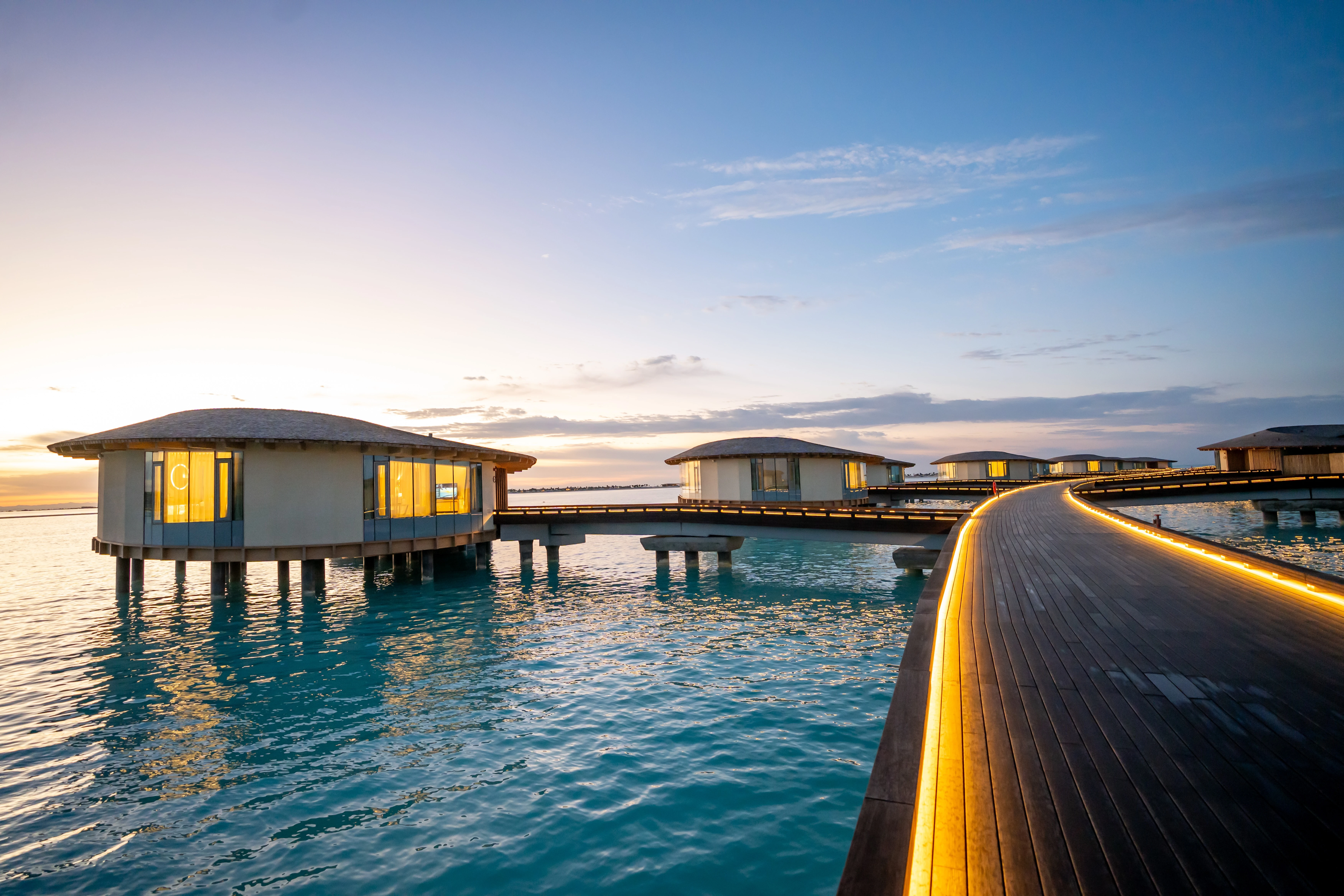 Illuminated pathways leading to over-sea villas at the St Regis Red Sea Resort