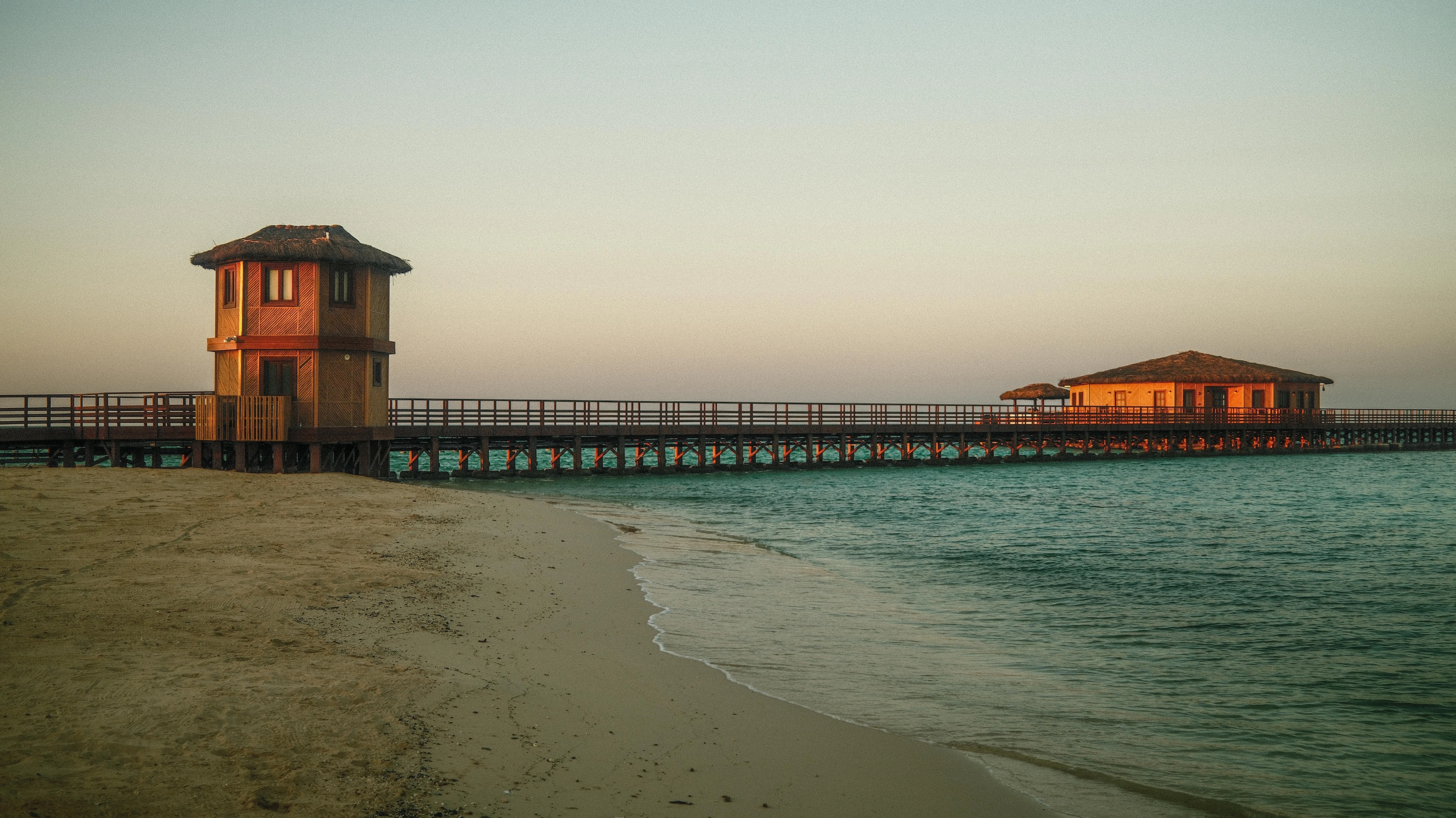 A pier stretching into the water from the beach on Thuwal island.