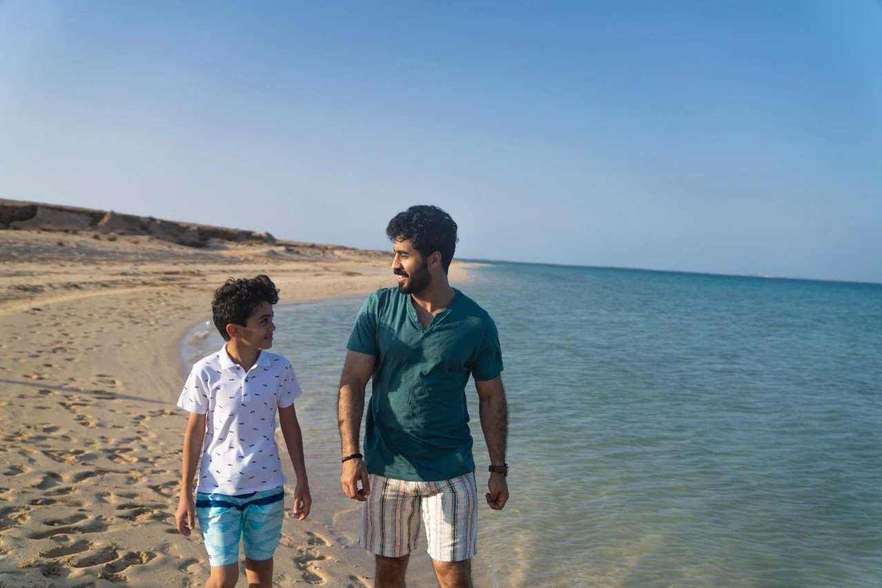 Father and son enjoying a day at the beach. STA