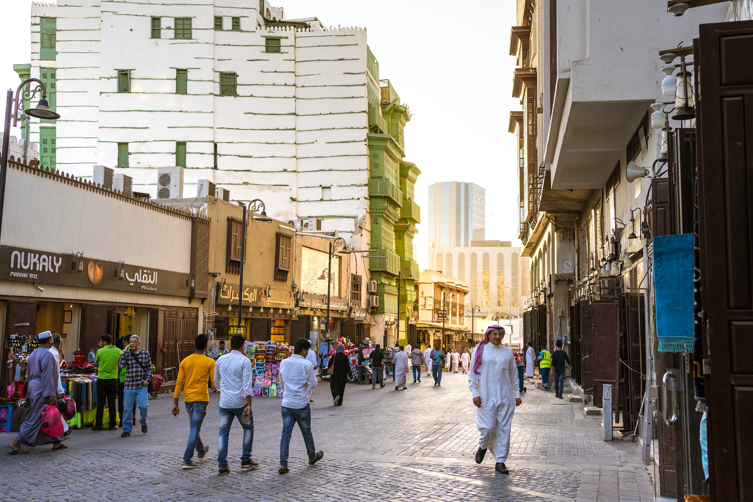People walking down a street in Al Balad
