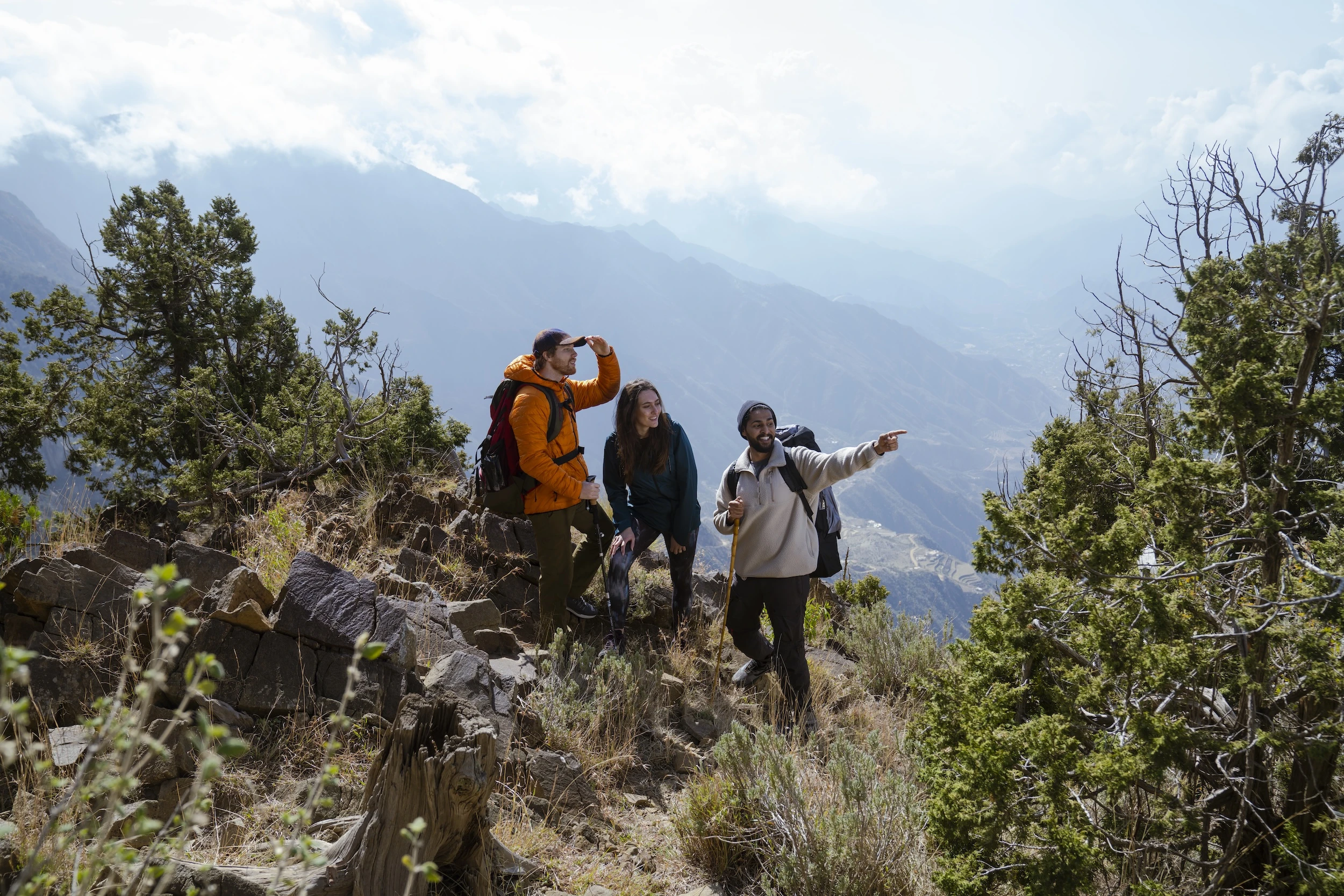 A man giving a couple directions while hiking in the Asir mountains