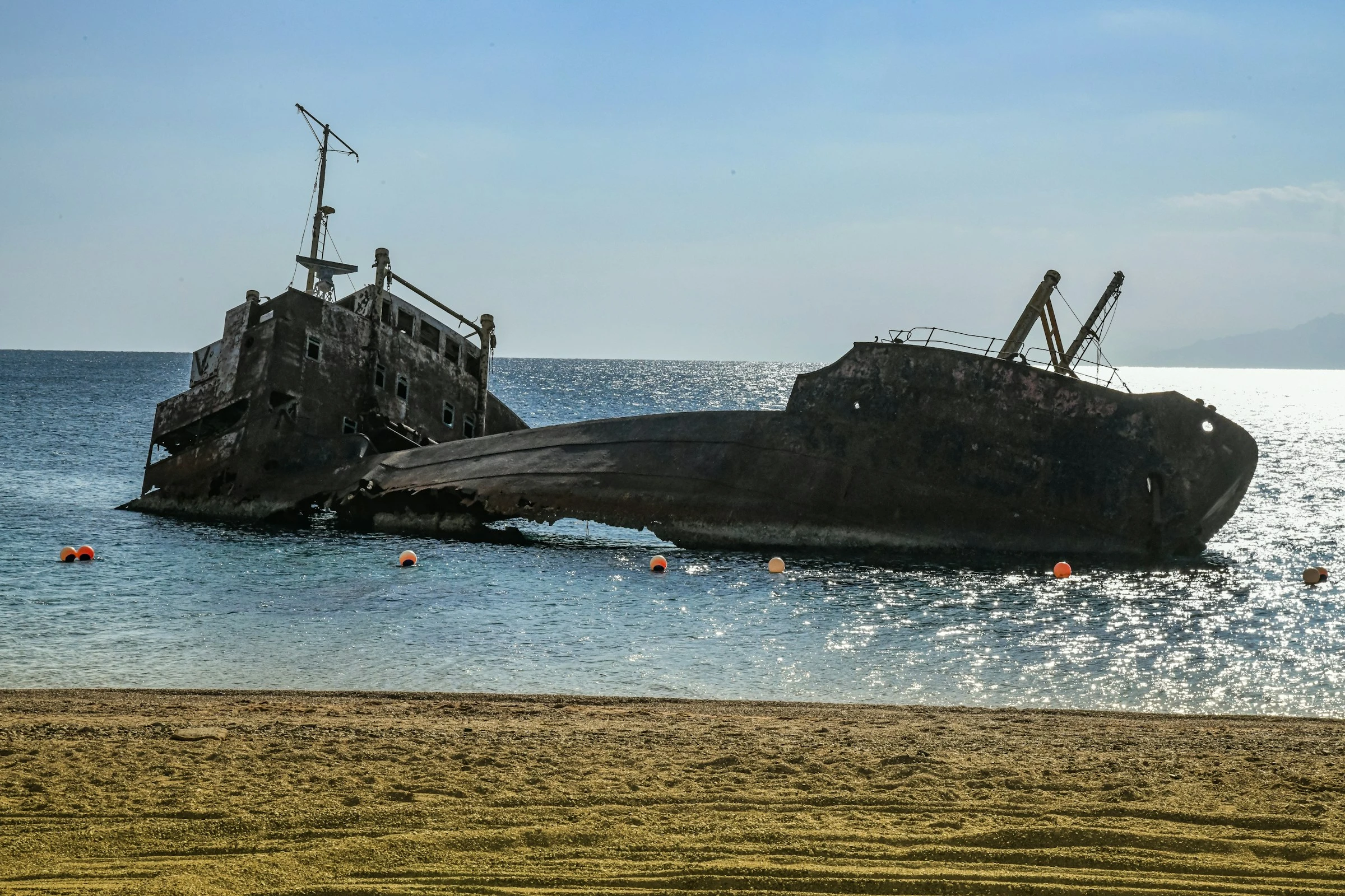 Stretch out on the sand and enjoy the unique view on Shipwreck Beach. Unsplash